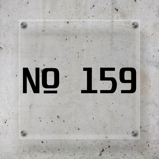 a modern tech style simple house/home front door number vinyl decal sticker placed on a acrylic plaque on a concrete wall.