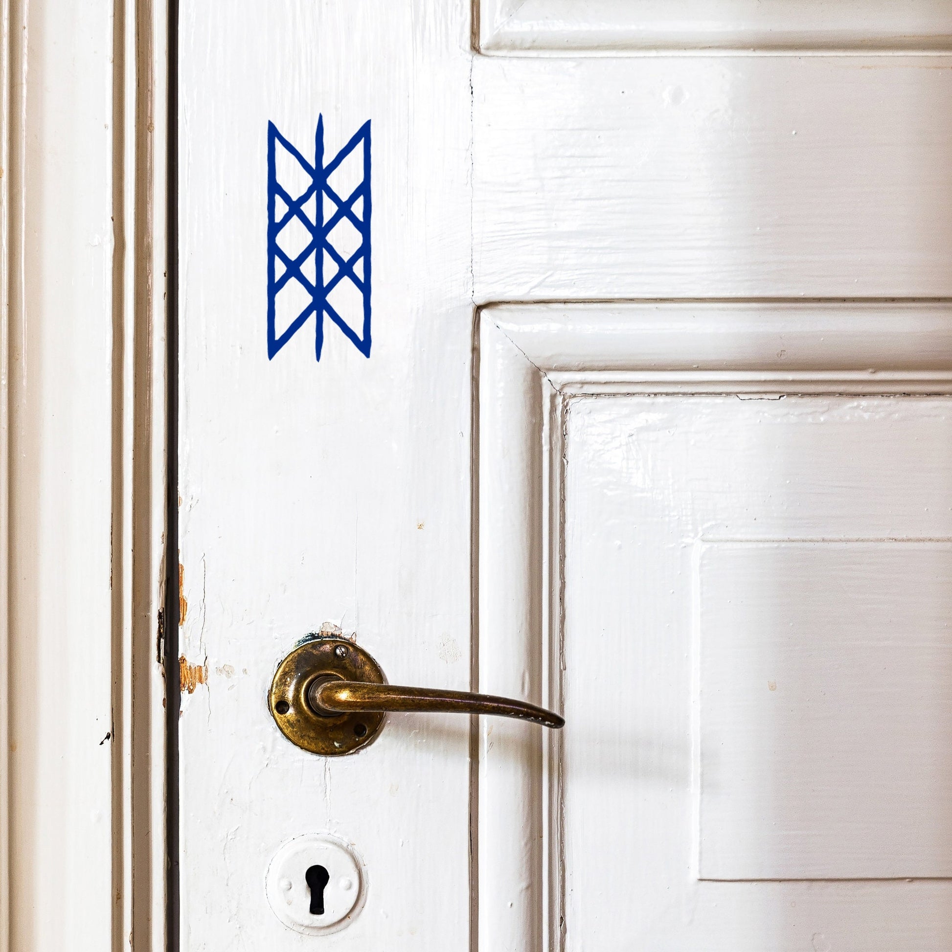 a viking web of wyrd symbol stuck onto an internal door